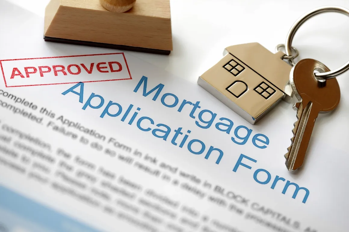 Approved mortgage application with house key.